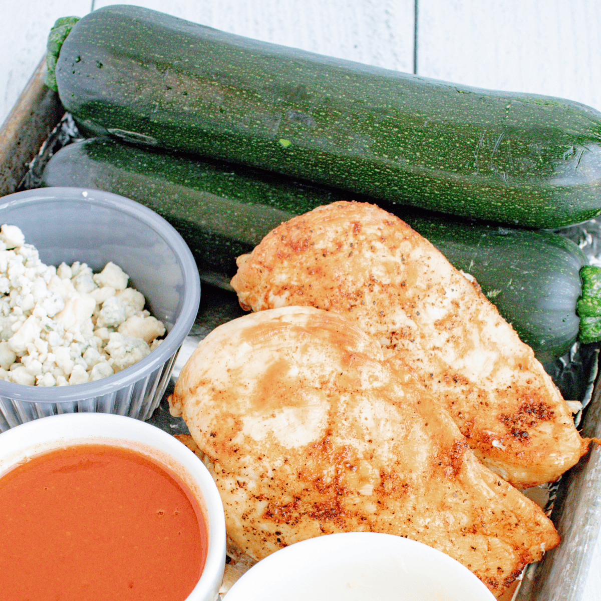 Ingredients needed for Air Fryer Zaatar Zucchini on kitchen table.