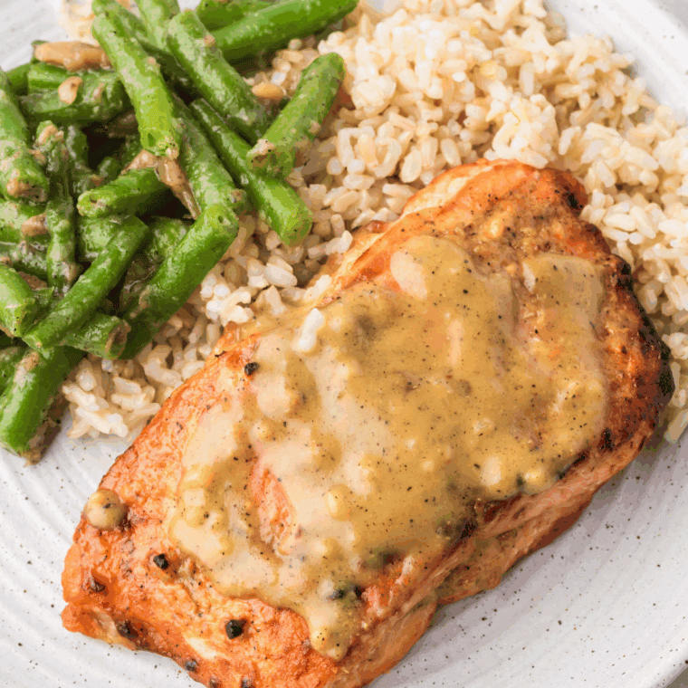 Plated miso salmon over rice with sesame and scallions.