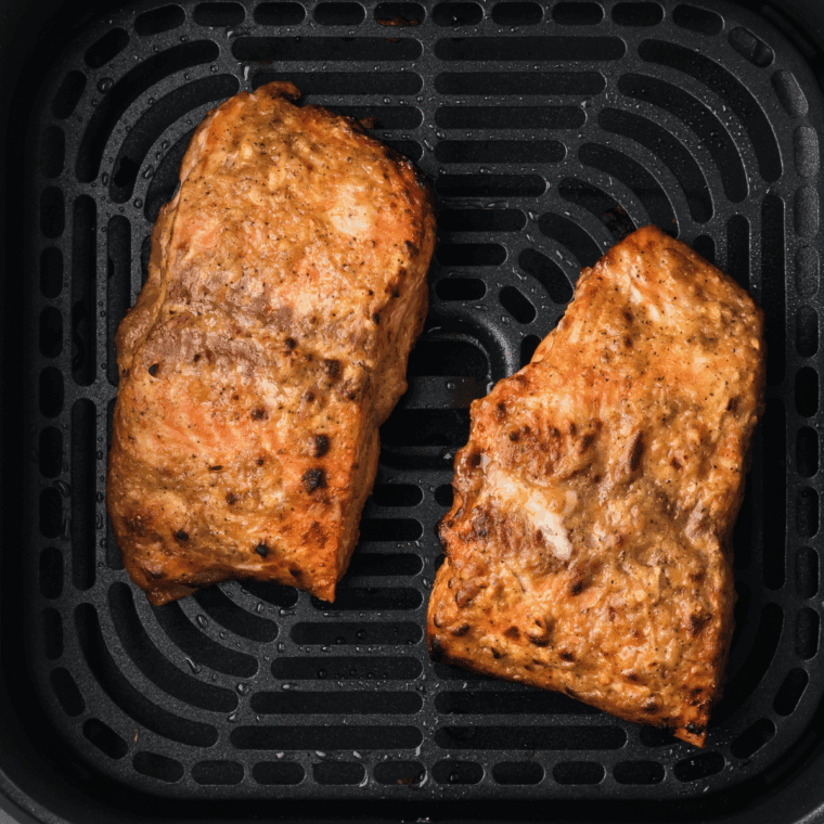 Baking glazed salmon fillets on parchment-lined tray.