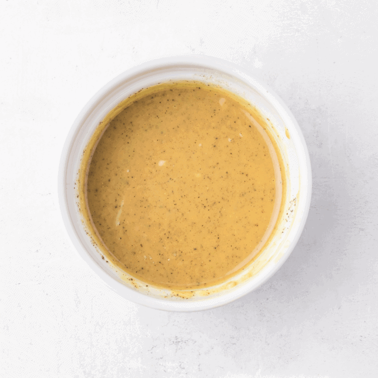 Cooking sweet miso glaze with garlic and ginger in saucepan.