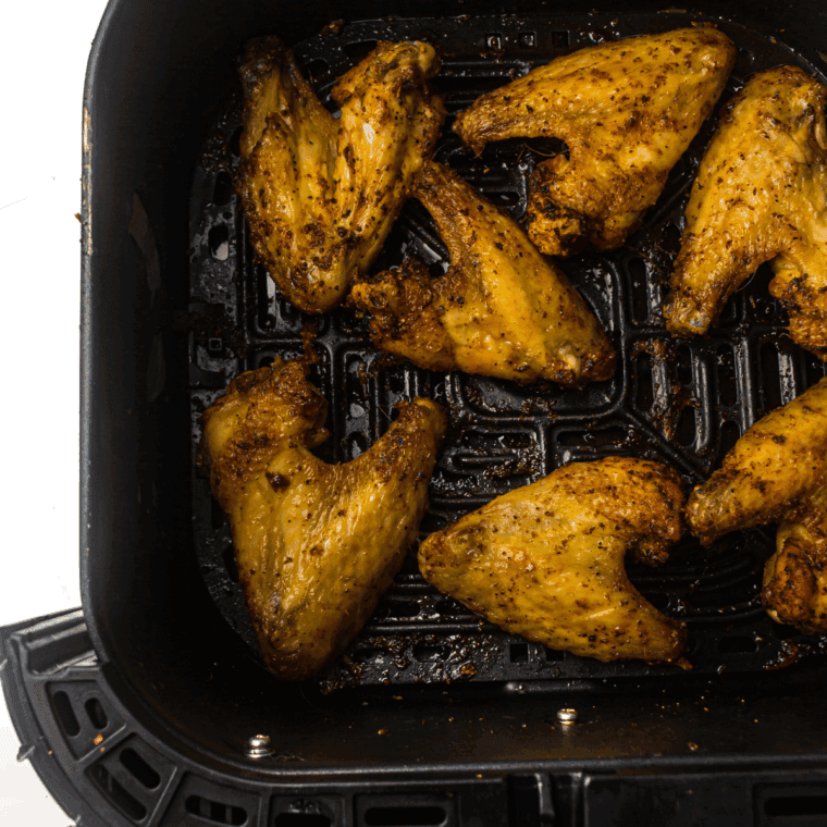 Air Fryer Domino’s Garlic Parmesan Wings in the air fryer basket cooked.