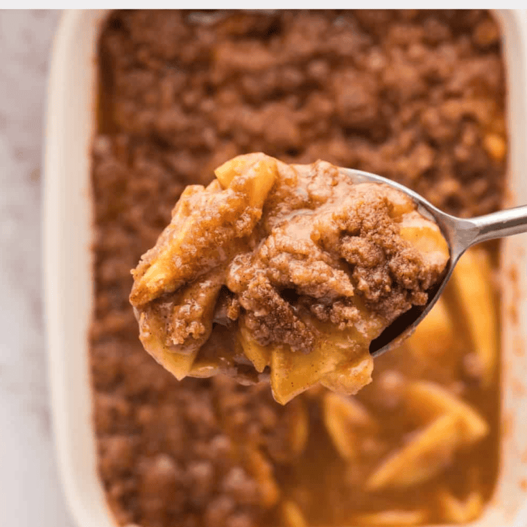 Close-up of tender cinnamon apples coated in a buttery glaze, served in a bowl for a comforting and delicious treat.