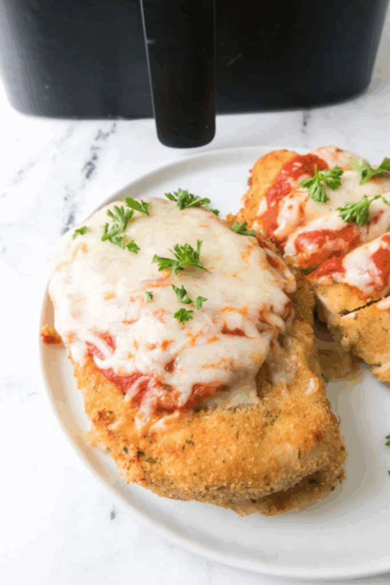 Homemade Maggiano’s Little Italy Chicken Parmesan served golden and cheesy with marinara sauce.