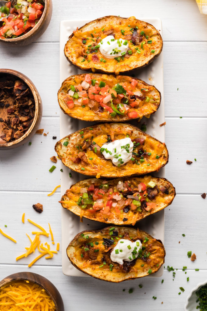 "Air Fryer Steakhouse Potatoes garnished with herbs on a serving dish."