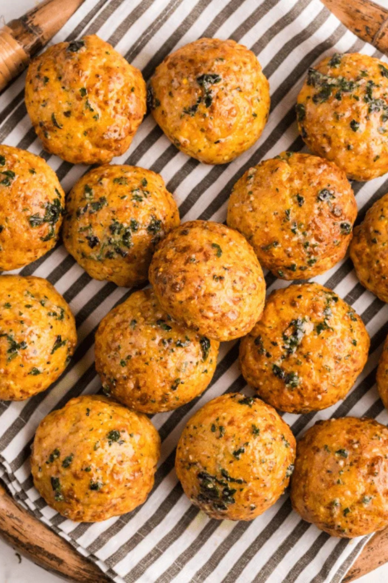 Plate of bite-sized air fryer cheese puffs perfect for dipping and snacking, freshly baked and crispy