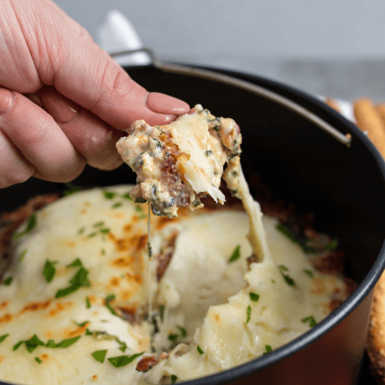 Air Fryer Cheesy Bacon Spinach Dip with melted cheese, crispy bacon, and fresh spinach in a golden, creamy dip