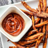 "Crispy Air Fryer cinnamon sweet potato fries sprinkled with cinnamon sugar."