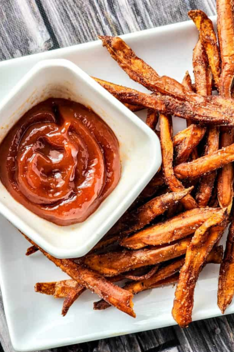 "Serving Air Fryer cinnamon sweet potato fries in a bowl, garnished with cinnamon sugar."