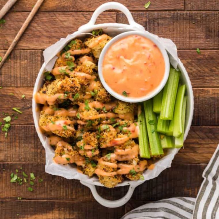 Air Fryer Parmesan Cauliflower bites golden and crispy, served on a white plate.