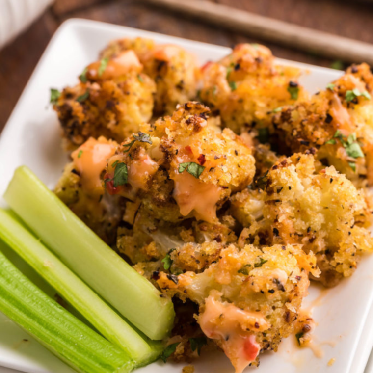 Plating the Air Fryer Parmesan Cauliflower, ready to serve with dipping sauce on the side