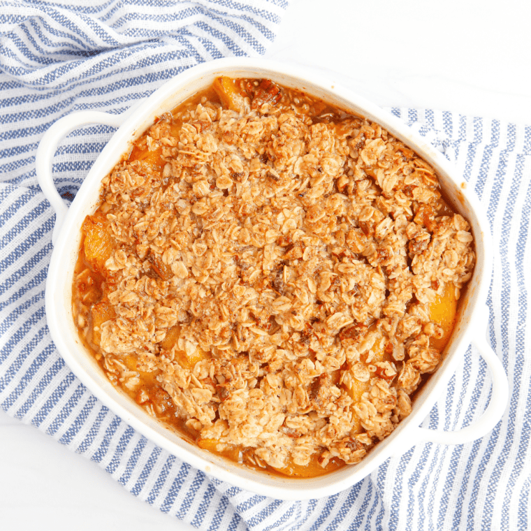 Warm Air Fryer Peach Crumble served in a bowl with golden topping and juicy peaches.