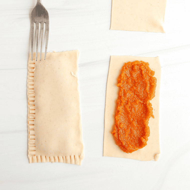 Rolling out dough for Air Fryer Pumpkin Pop-Tarts, and adding filling.
