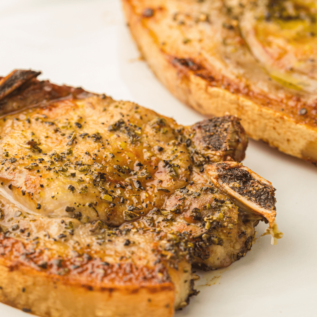 Crispy and flavorful Air Fryer Ranch Pork Chops, seasoned with ranch dressing mix, served as a quick and tasty meal.