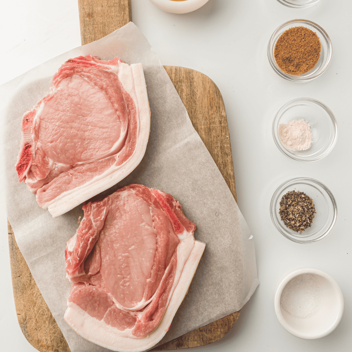 Ingredients needed for Air Fryer Ranch Pork Chops on kitchen table.