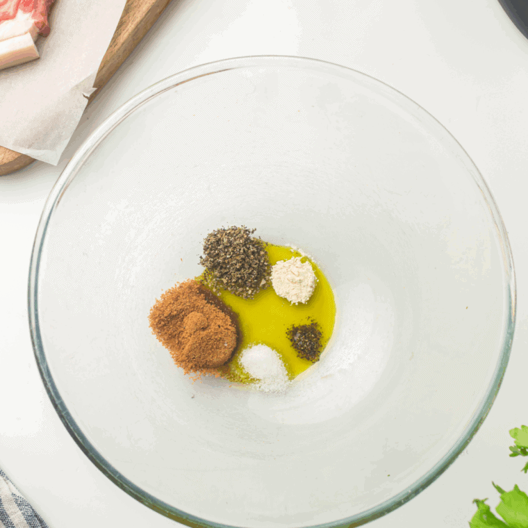 Add the seasoning mix to a mixing bowl, add the olive oil, ready to coat the pork chops.