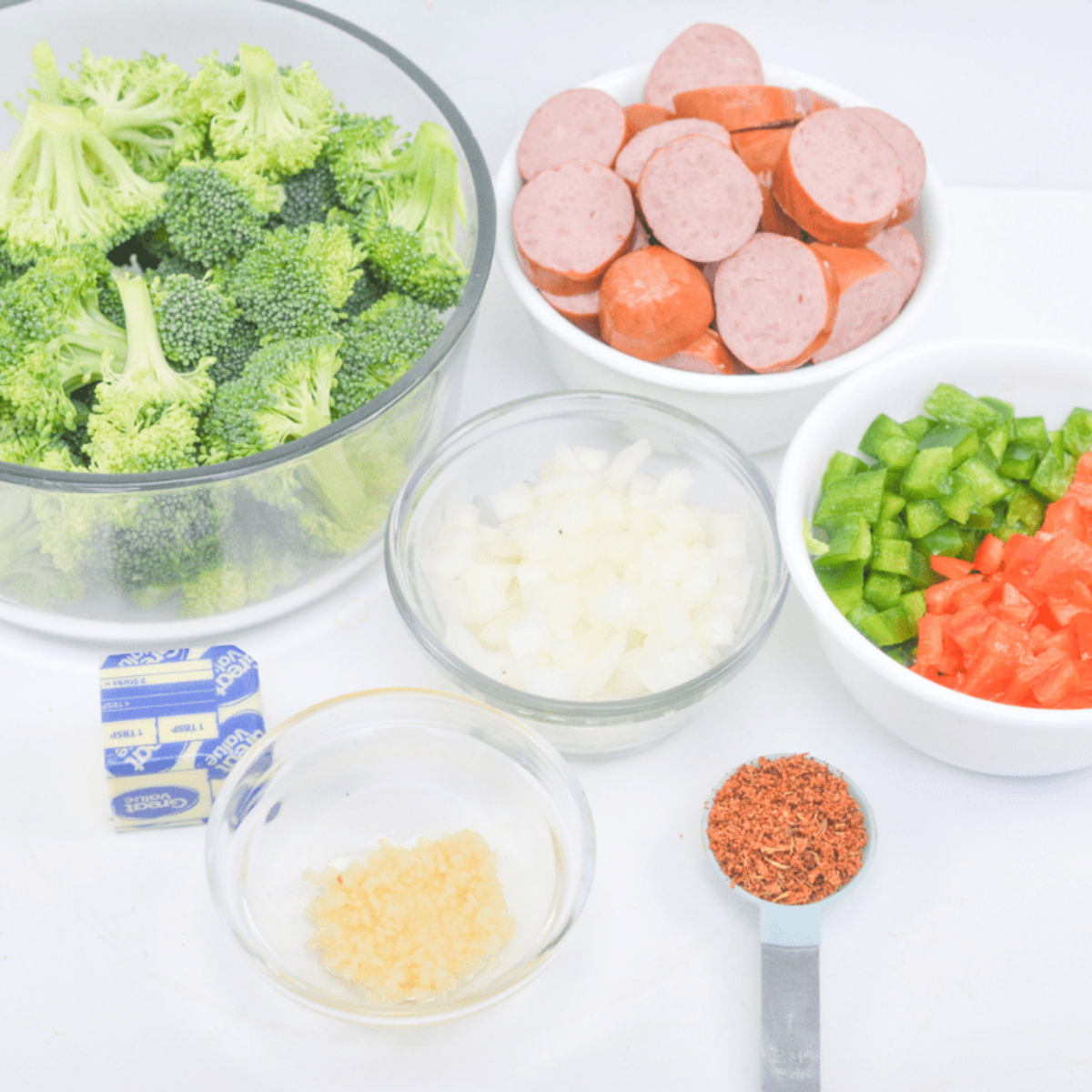Broccoli and Sausage in Air Fryer ingredients on kitchen table.