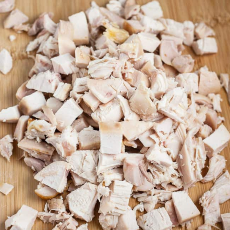 Chicken breasts placed in the air fryer basket, cooking until golden and cooked through.