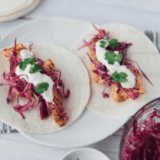 Close-up of homemade Blackened Baja Fish Tacos with crispy seasoned fish, fresh slaw, and zesty sauce on tortillas.