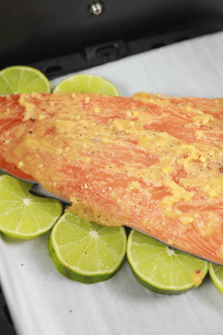 Air fryer cooking cedar plank salmon at 400 degrees Fahrenheit until flaky.
