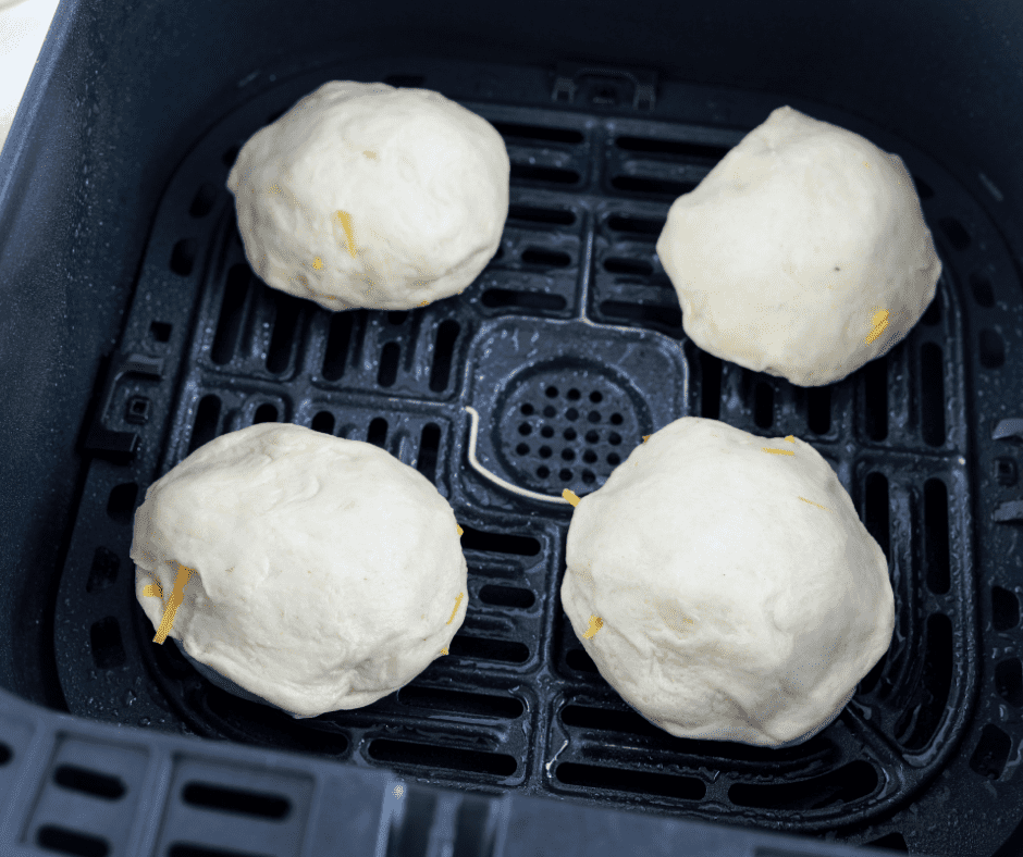 uncooked cheeseburger bombs in air fryer basket