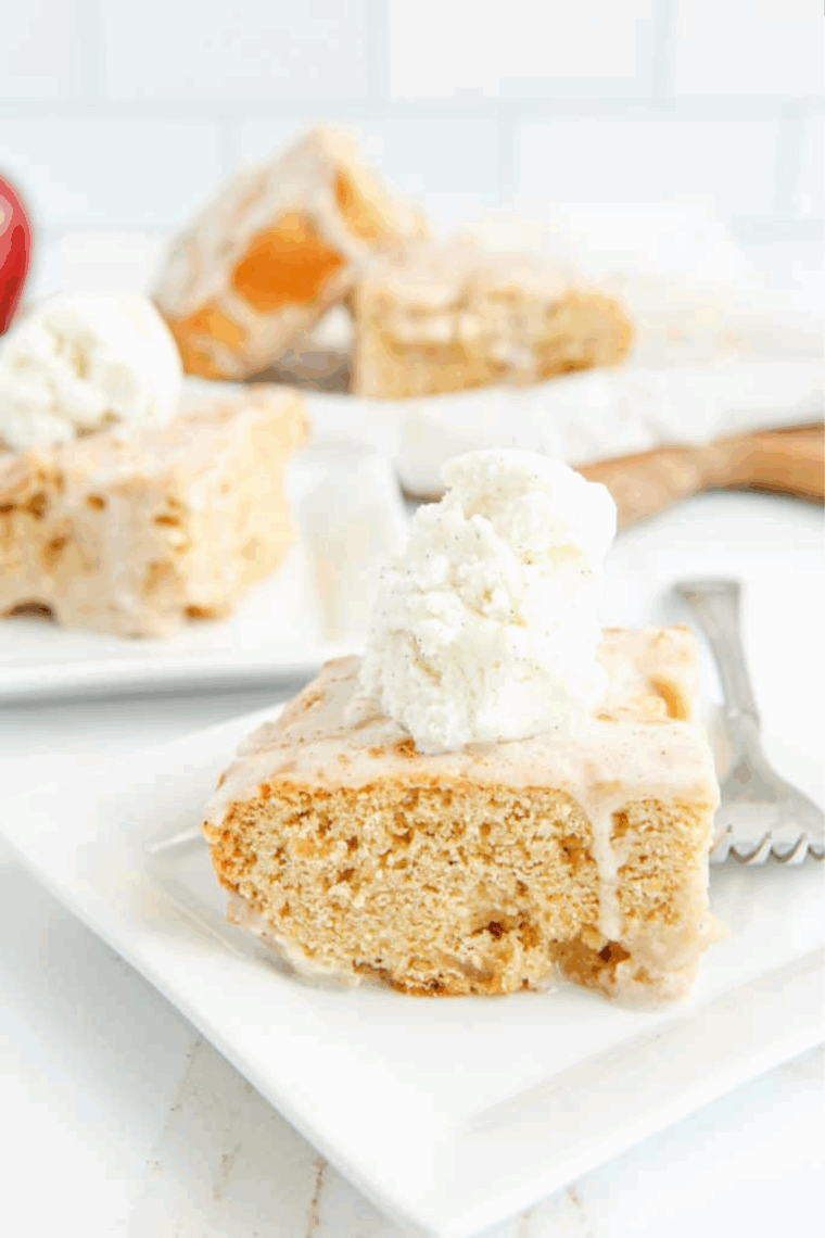 Close-up of a warm butter pecan blondie topped with vanilla ice cream and maple sauce.