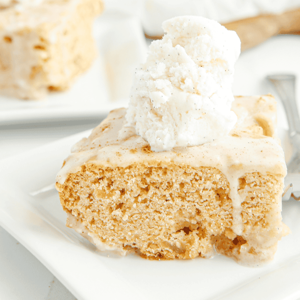 Close-up of Copycat Applebee’s Butter Pecan Blondies topped with pecan butter sauce and vanilla ice cream.