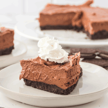 Homemade Copycat Cheesecake Factory Godiva Chocolate Cheesecake with layers of chocolate cake, cheesecake, and ganache.