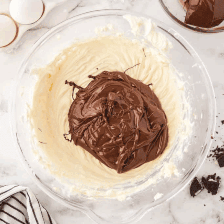 Mixing chocolate cheesecake filling with cream cheese and cocoa.