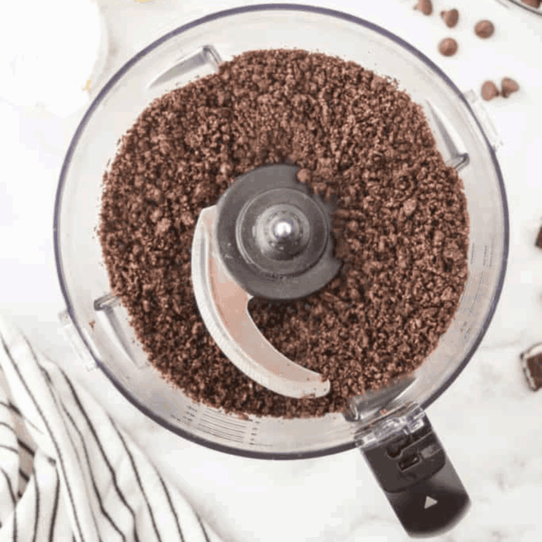 Pressing Oreo crumb crust into springform pan for cheesecake.
