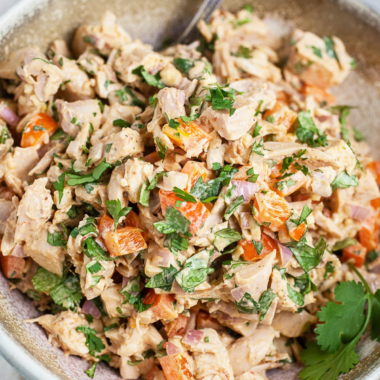Close-up of creamy Southwest chicken salad showing corn and sun-dried tomato pieces.