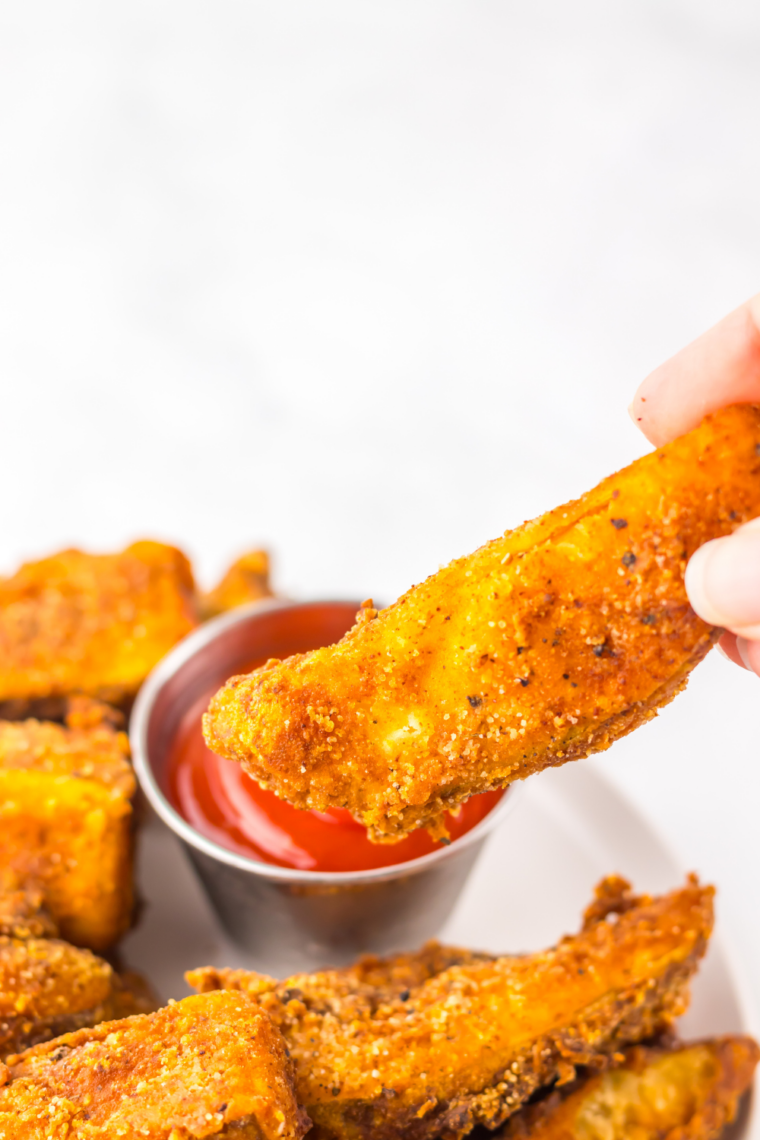 Double-fried potato wedges draining on paper towels after cooking until crispy and golden brown