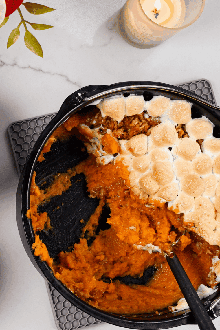 Sweet potato casserole made with canned yams, topped with toasted marshmallows in a white baking dish.