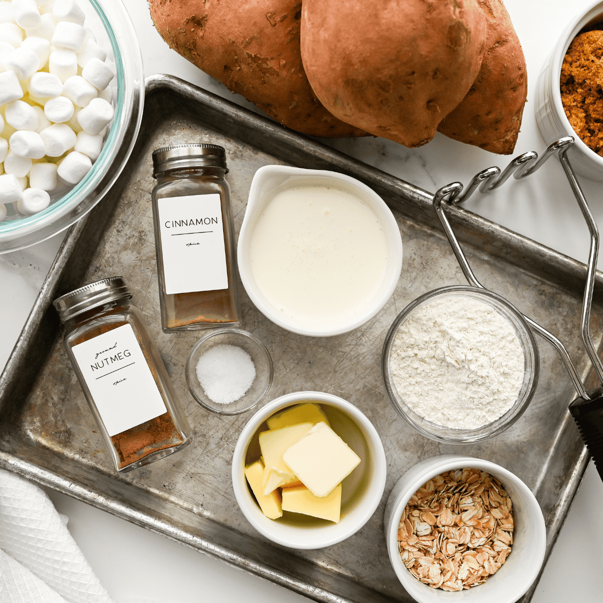 Ingredients needed for Easy Sweet Potato Casserole With Canned Yams on kitchen table.
