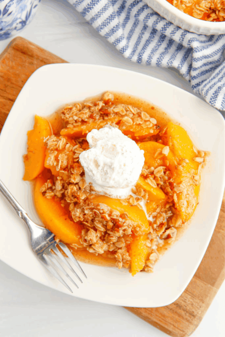 Golden Corral-style peach cobbler with juicy peaches and a golden, flaky buttery crust.