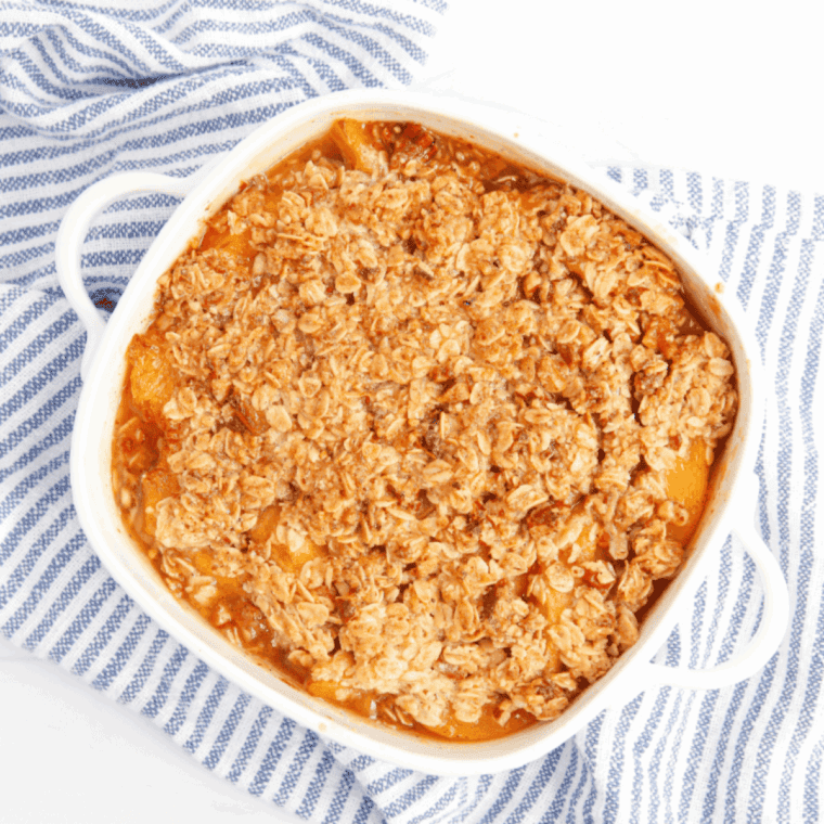 Homemade Golden Corral Peach Cobbler with juicy peaches and golden buttery crust served warm with vanilla ice cream.