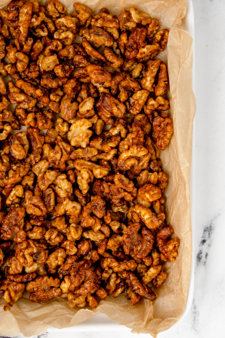 Sweet and crunchy air fryer honey roasted walnuts served in a wooden bowl for snacking.