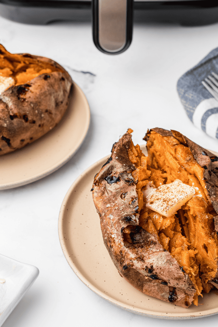 Instant read thermometer showing 165 degrees F inserted into the center of a reheated sweet potato