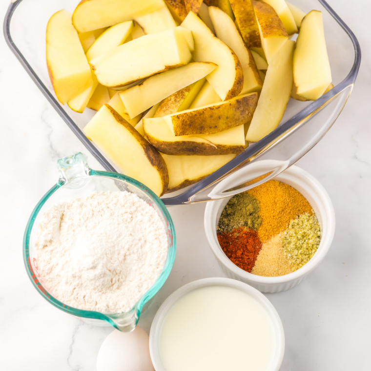Ingredients needed for Copycat Popeyes Cajun Battered Fries on kitchen table.