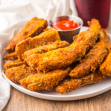 Basket of homemade Popeyes Cajun Battered Fries with crispy seasoned coating and dipping sauce