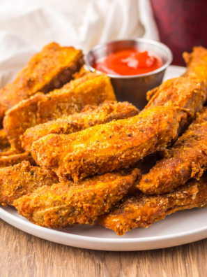 Basket of homemade Popeyes Cajun Battered Fries with crispy seasoned coating and dipping sauce