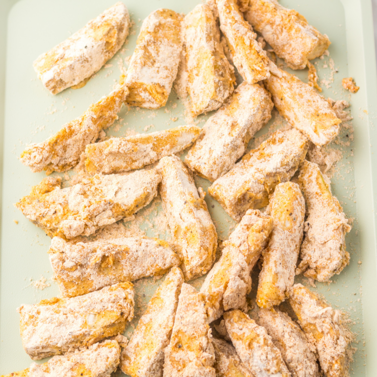 Potato wedges dredged in flour, dipped in egg mixture, and coated in seasoned flour before frying
