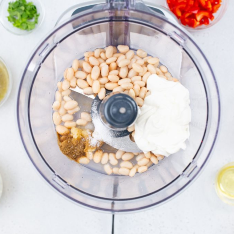 Ingredients for making White Chicken Chili Dip in the air fryer, including white beans and rotisserie chicken.