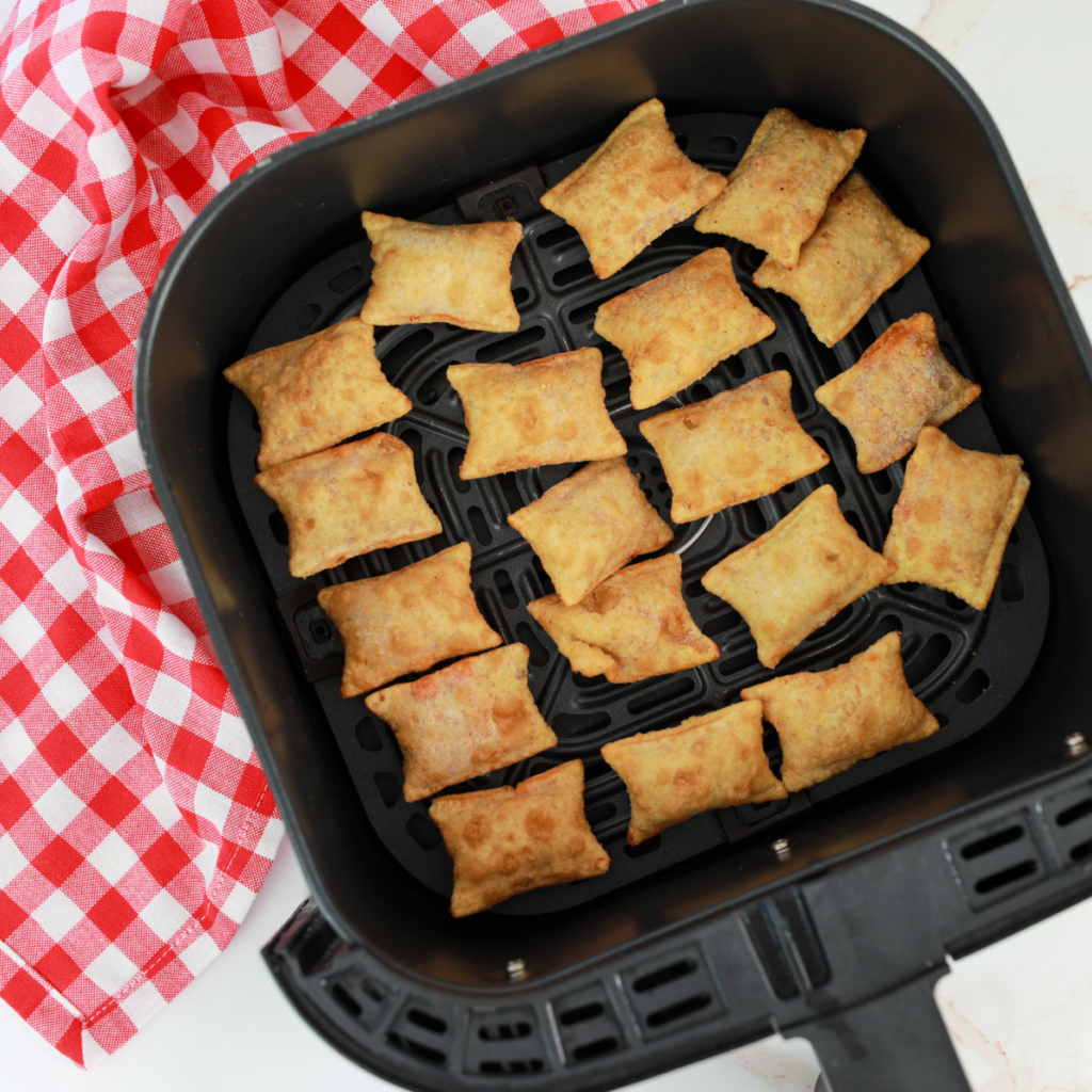 Preheat the Air Fryer:

Preheat your air fryer to 380 degrees F (193°C) for 3-5 minutes. Preheating ensures even cooking and a crispy result.

Lightly Coat with Cooking Spray:

Spray the frozen pizza rolls with cooking spray, or brush the air-fried pizza rolls with olive oil, with a pastry brush.  This helps them become extra crispy and golden brown.

Arrange in the Air Fryer:

Place the pizza rolls in a single layer in the preheated air fryer basket. Ensure they are not overcrowded to allow proper air circulation. You may need to cook them in batches.

Air Fry the Pizza Rolls:

Set the cook time for 6-8 minutes, shaking the basket or flipping them halfway through the cooking process for even browning.

Optional Toppings:

If you want to add extra toppings, such as shredded mozzarella cheese, Parmesan cheese, Italian seasoning, red pepper flakes, or a drizzle of olive oil, do so during the last 2 minutes of cooking. This allows the toppings to melt or seasonings to infuse.

Check for Crispy Perfection:

The pizza rolls are done when they are golden brown and crispy. Keep an eye on them during the last few minutes to avoid overcooking.

Serve Hot:

Remove the pizza rolls from the air fryer and let them cool for a minute or two. Serve them hot with marinara sauce for dipping.

Optional Garnishes:

Garnish with torn or chopped fresh basil leaves or an extra sprinkle of Parmesan cheese for added flavor and presentation.

Season as Needed:

Season the pizza rolls with a pinch of salt, freshly ground black pepper, or additional seasoning if desired.

Enjoy!- Serve your hot and crispy air fryer frozen pizza rolls as a tasty snack or appetizer. Dip them in marinara sauce, ranch dressing or extra pizza sauce for the ultimate flavor experience.