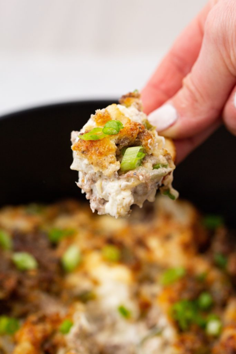 Finished Air Fryer Philly Cheesesteak Dip served in a bowl with tortilla chips on the side.