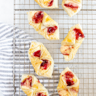 Flaky air fryer puff pastry Danish showing golden layered edges and jam center