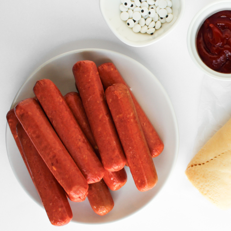 Ingredients needed for Air Fryer Sauerkraut Hot Dogs on kitchen table.
