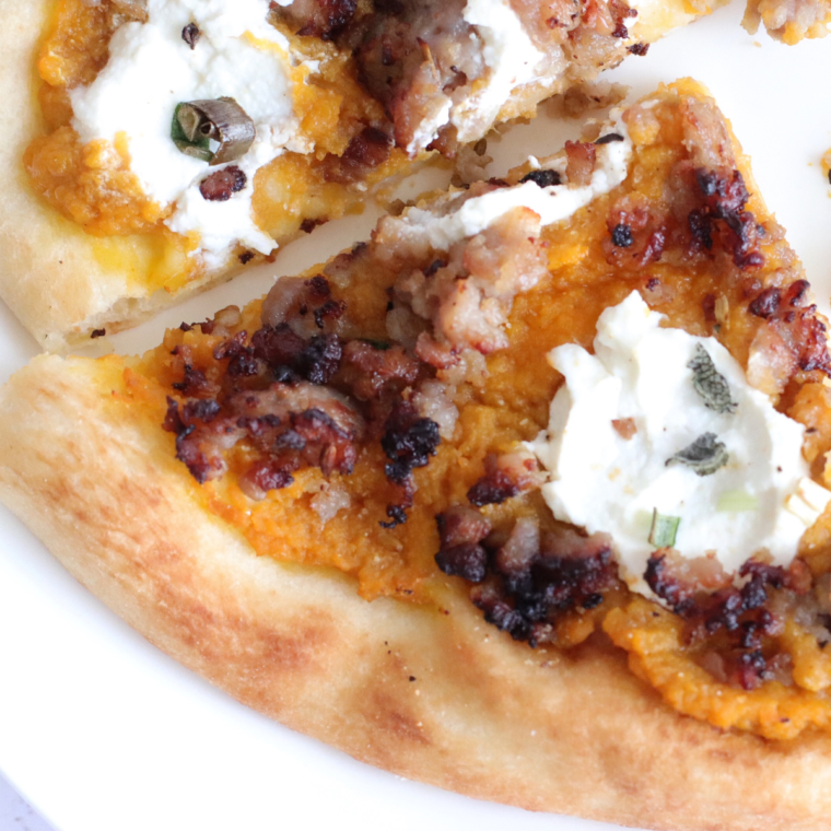 A delicious slice of Air Fryer Savory Pumpkin Ricotta Pizza topped with creamy ricotta and roasted pumpkin, served on a golden, crispy crust.