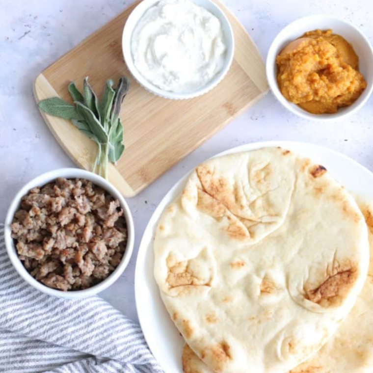 Ingredients needed for Air Fryer Savory Pumpkin Ricotta Pizza on kitchen table.