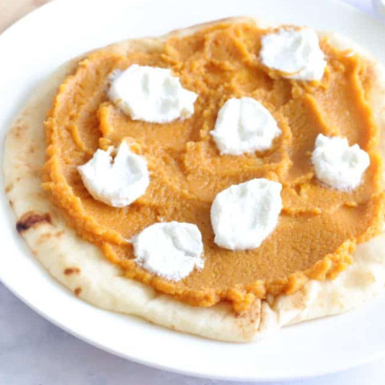 Adding dollops of ricotta cheese on top of the pumpkin spread for the Air Fryer Savory Pumpkin Ricotta Pizza.