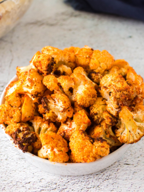 Bowl of Air Fryer Tandoori Cauliflower (Gobi Tikka) with golden-brown, crispy pieces of cauliflower coated in a spiced yogurt marinade.